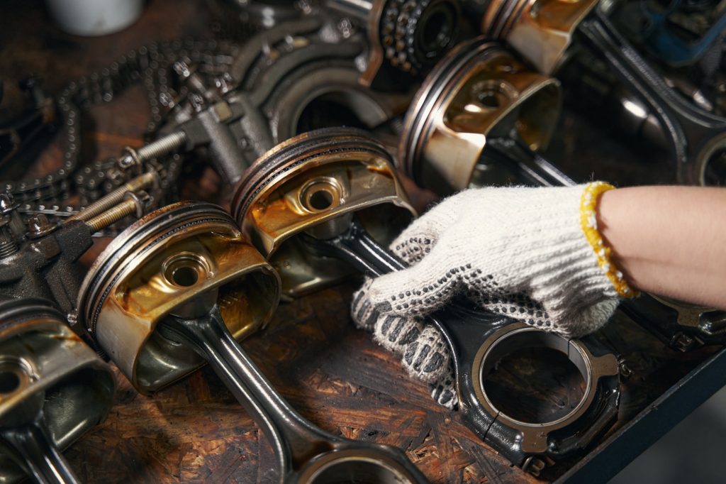 Auto mechanic repairing car parts in automobile garage